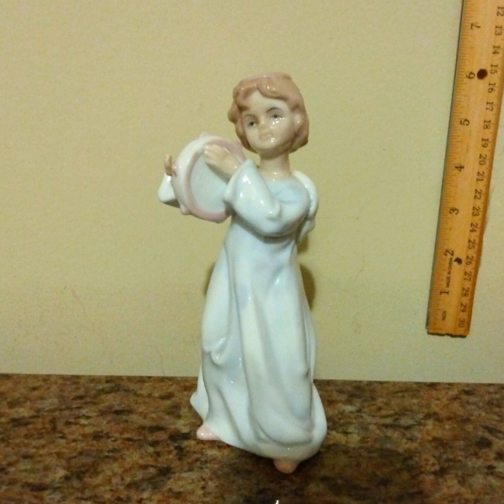 Vintage Angel playing the tambourine